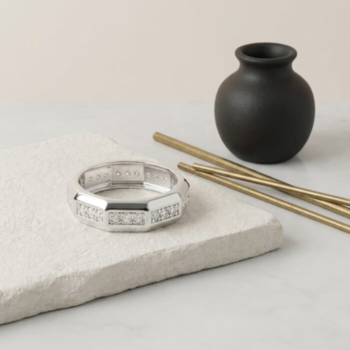 Premium silver designer ring with geometric CZ pattern displayed on stone surface – unisex fashion ring