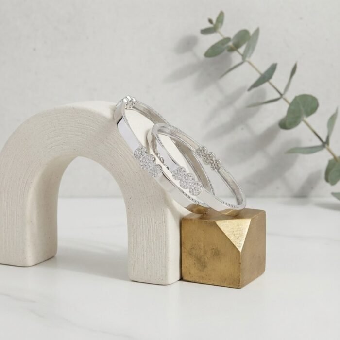Two tone micro silver bangle displayed on modern ceramic arch