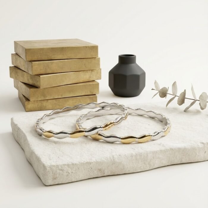 Two tone sterling silver bangle with wave design on stone slab